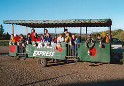 Educational school tours board the apple express to tour the farm and orchards at Lewis Farm Market, Corn Maze & Petting Zoo in New Era, Michigan, north of Grand Rapids